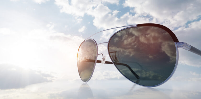 Polarized sunglasses on sunny sky. UV protection, polarization